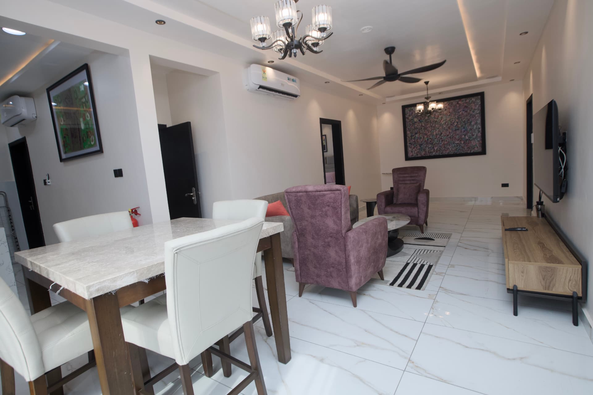 Golden Penthouse living and dining area with marble dining table